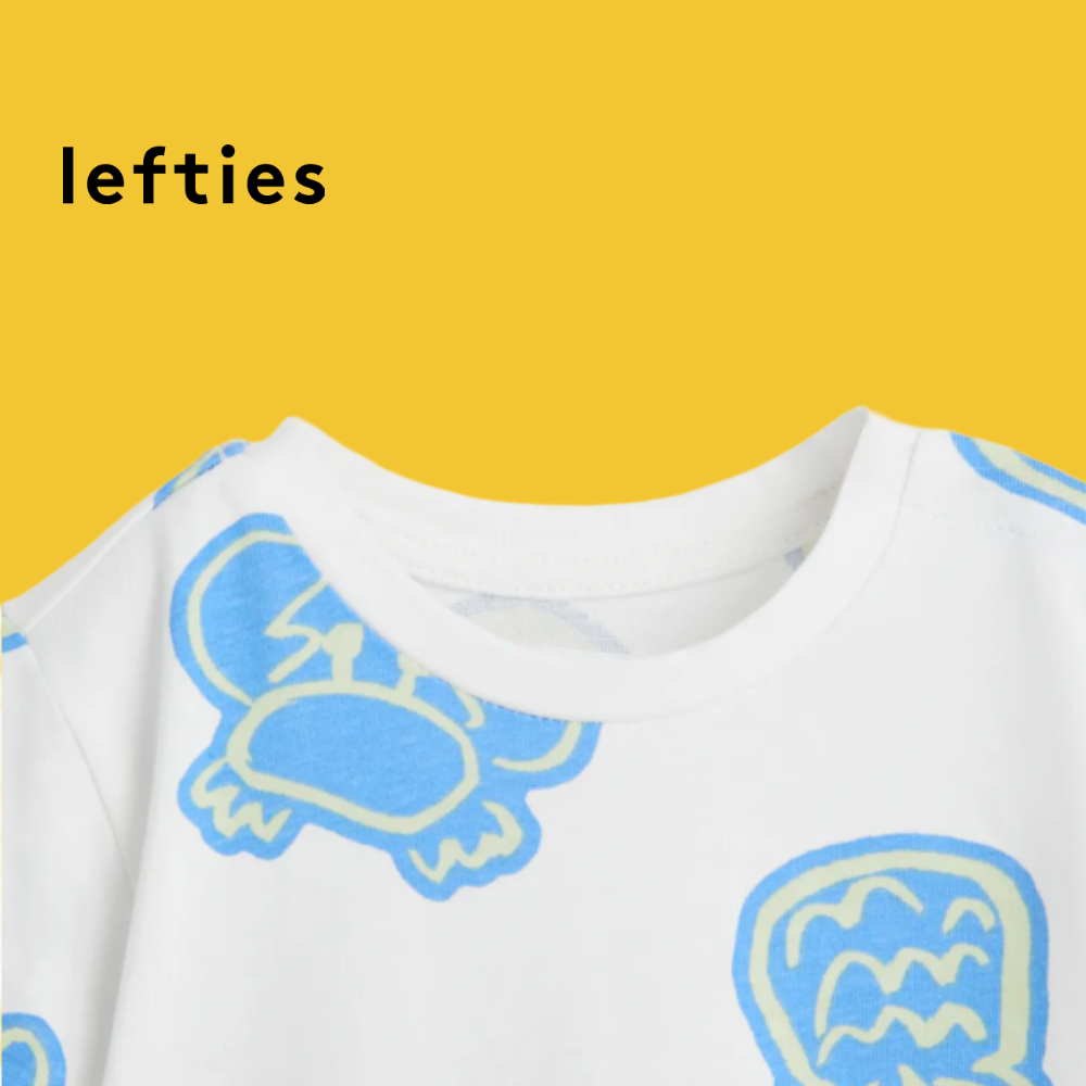 LEFTIES WHITE ROMPER WITH BEACH ELEMENT DOODLES